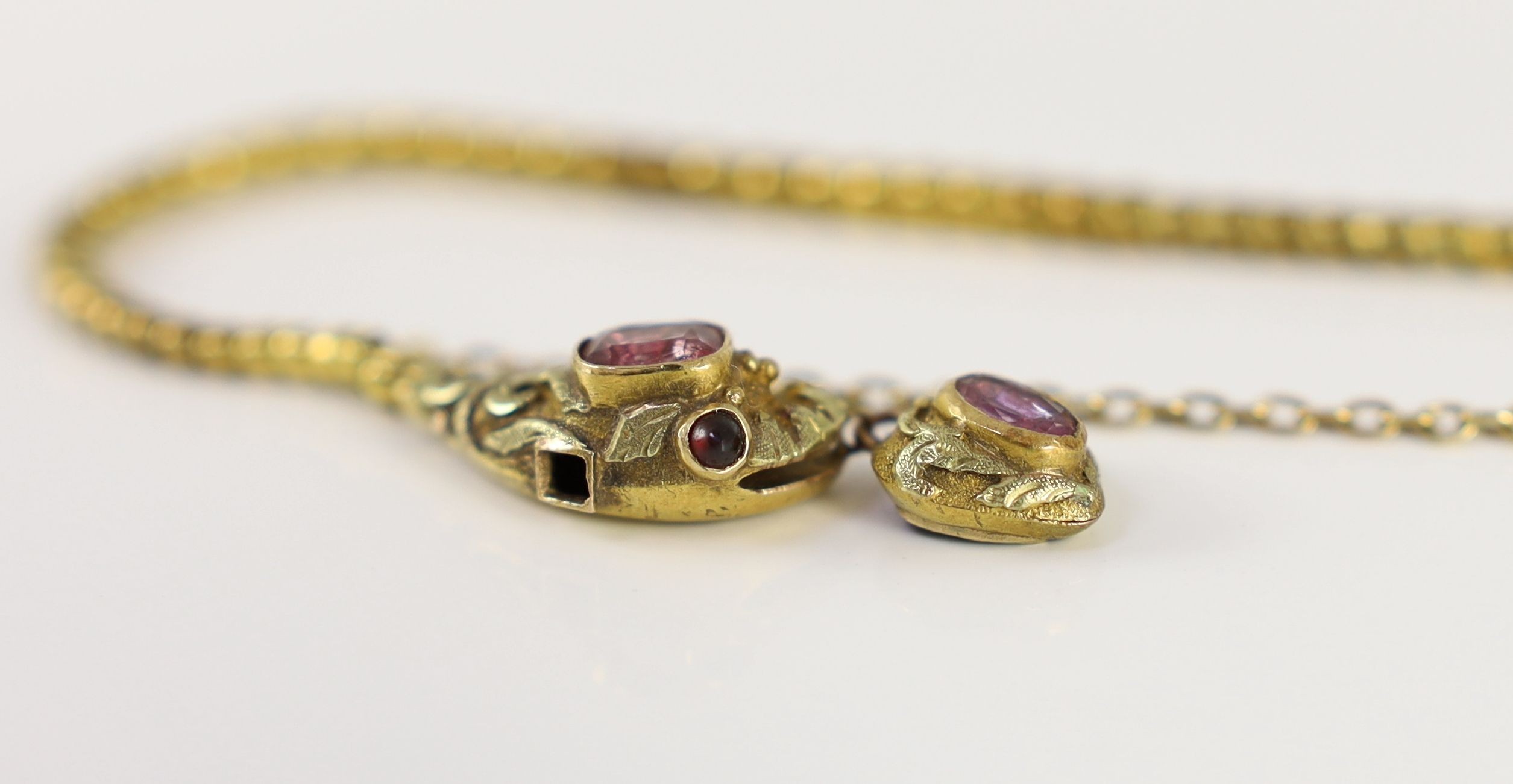 An early 19th century two colour gold and foil backed pink gem set serpent head and snake link bracelet